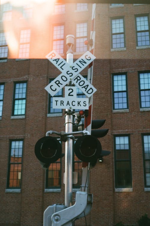 White and Black Rail Road Crossing Sign