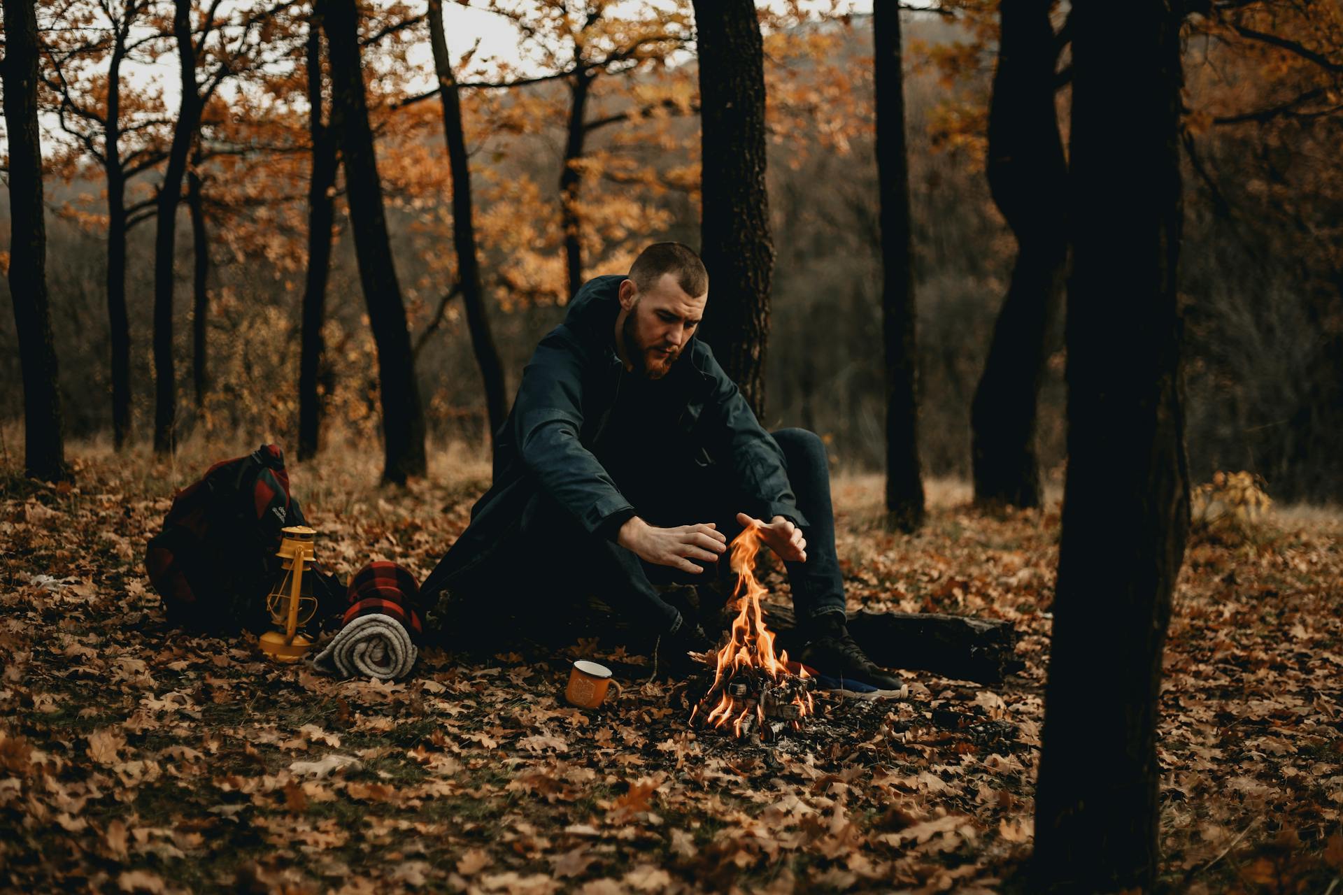 An Adventurer Keeping Himself Warm by the Campfire