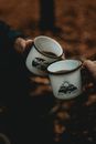Person Holding White and Black Ceramic Mug