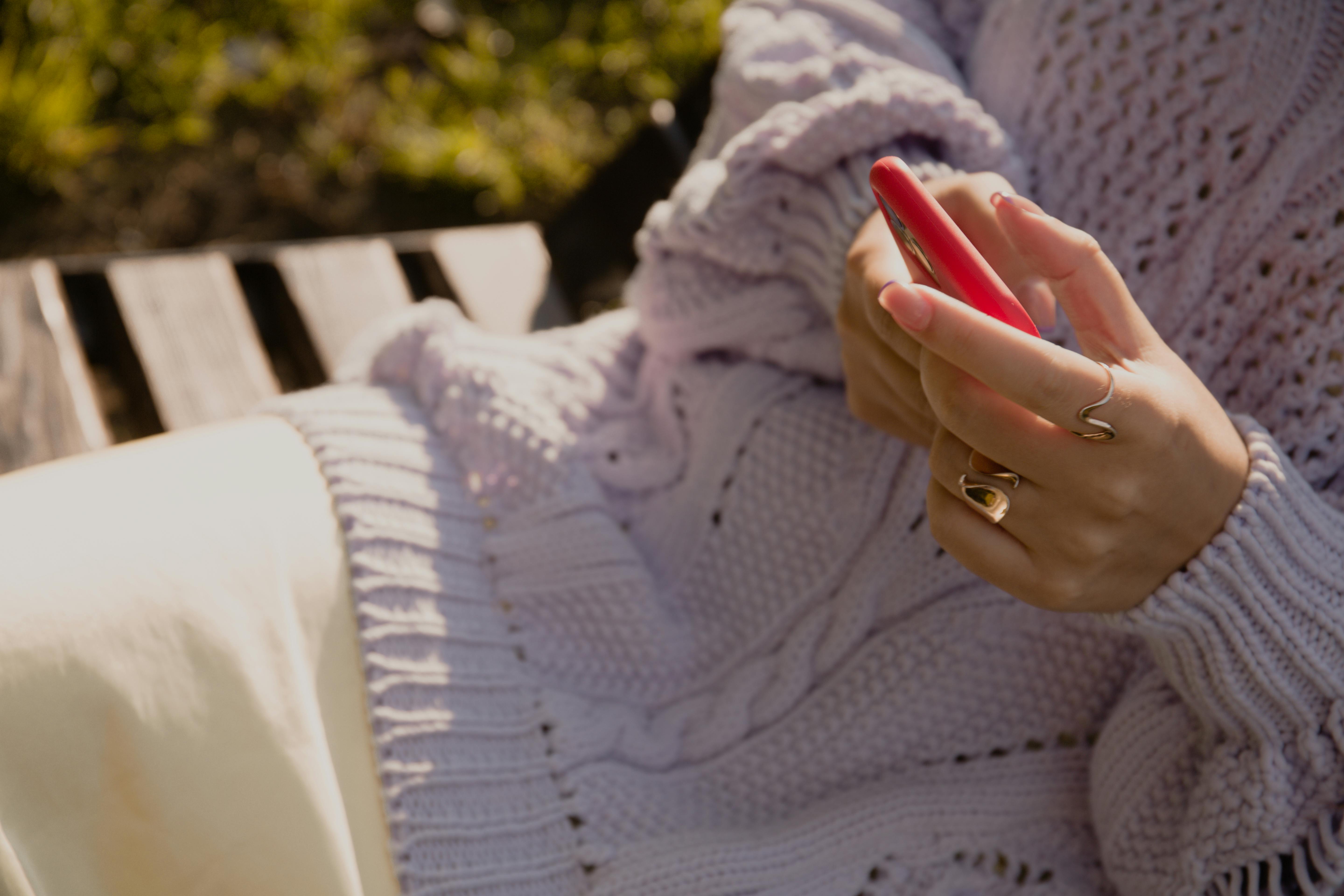 person sitting on a bench in nature, looking peaceful with phone turned off