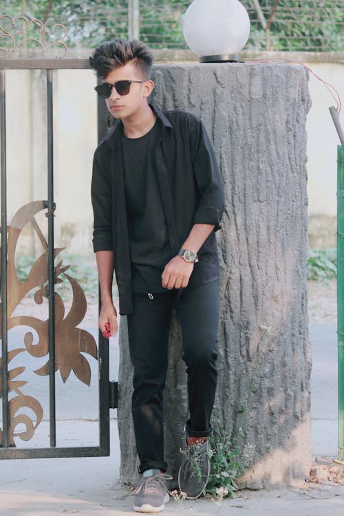 A Man in Sunglasses and a Black Outfit