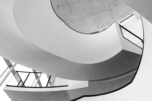 Grayscale Photo of Spiral Stairs