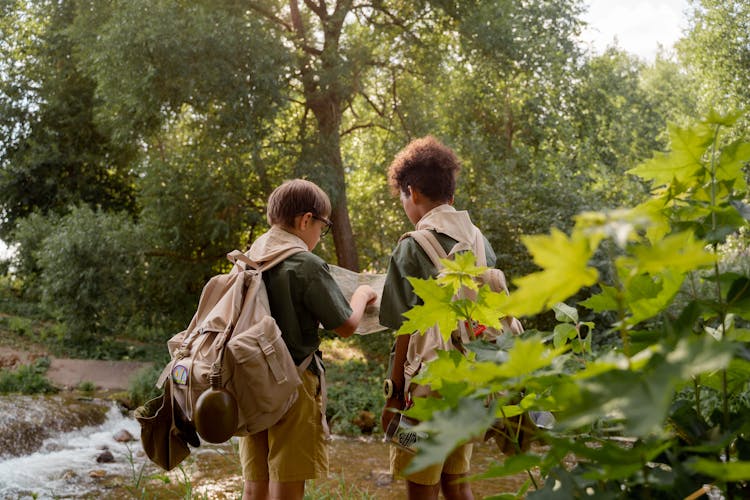 Scout Pointing On Map By River