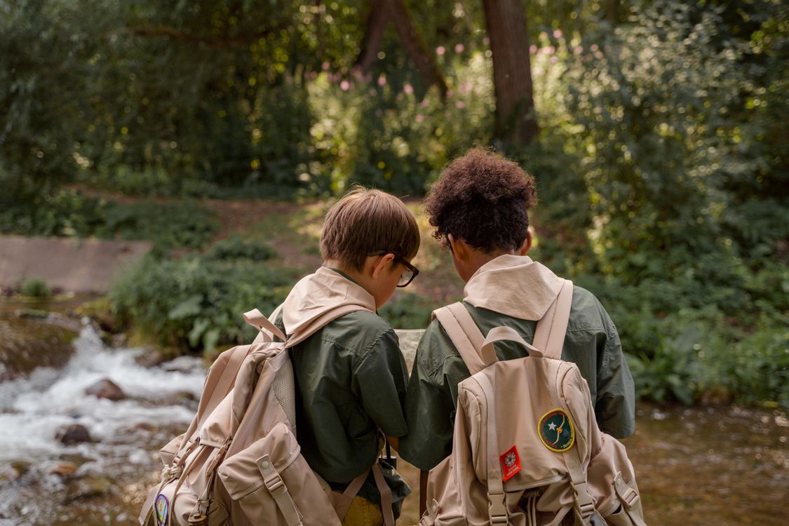 Back View of Two Boy Scouts Carrying a Backpack · Free Stock Photo