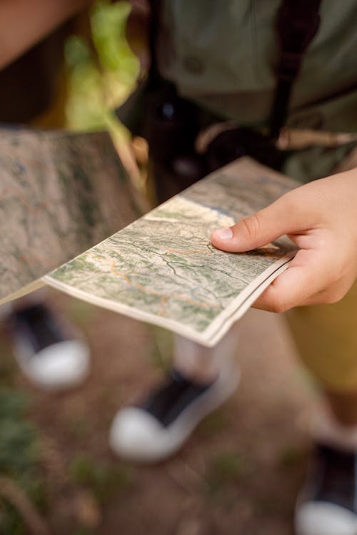 Free A Person Holding a Map Stock Photo