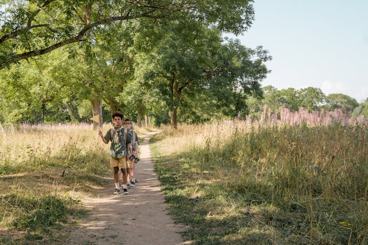 Kids Walking On A Pathway