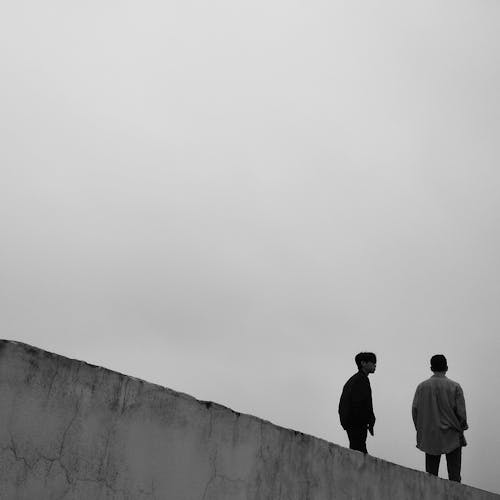 Free Men Standing on Top of a Building Stock Photo
