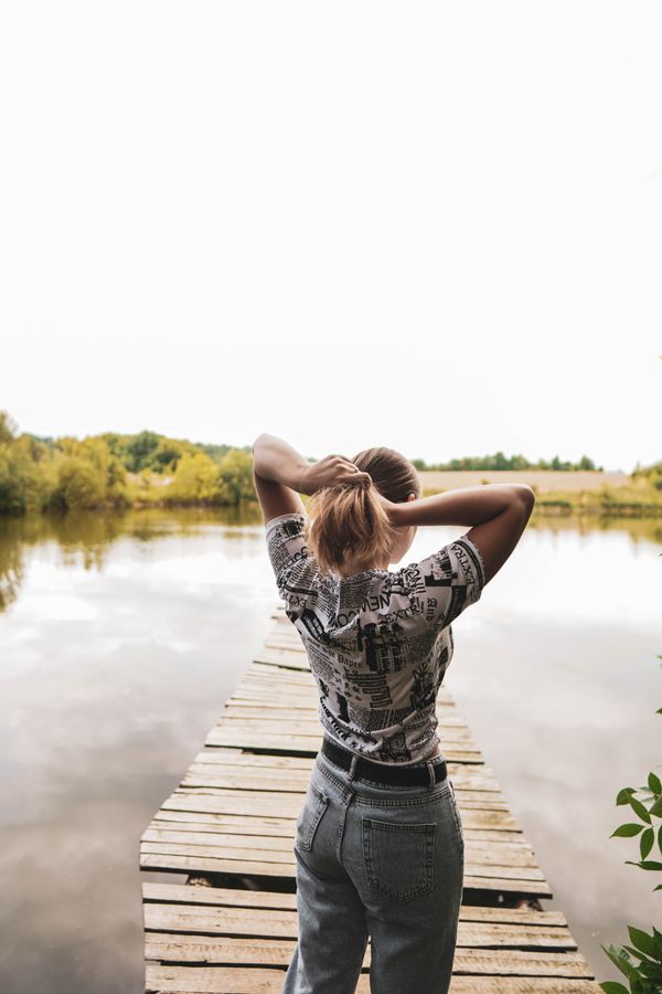 Woman with long styled wavy hair, back view