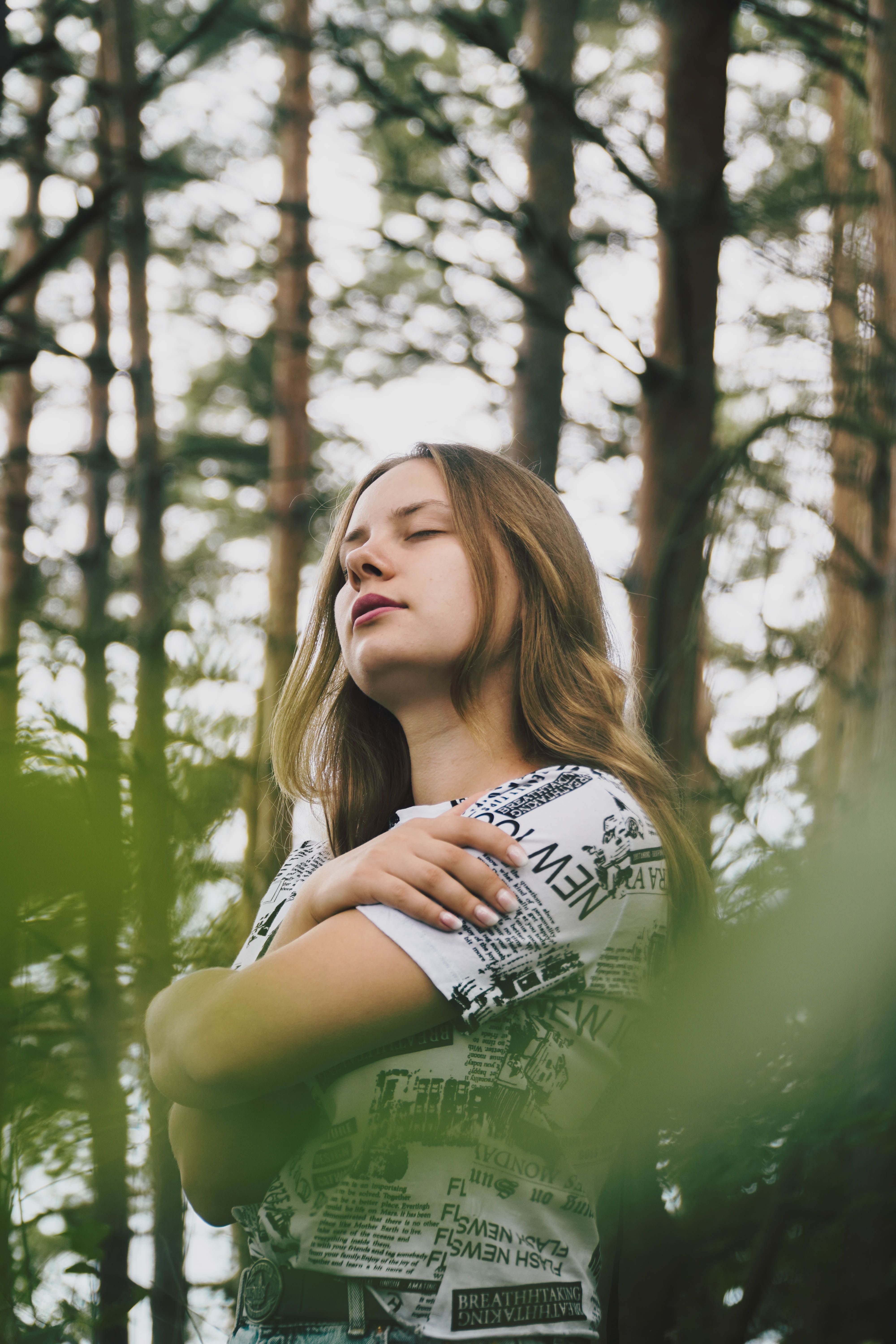 A Woman in the Forest With Her Eyes Closed · Free Stock Photo
