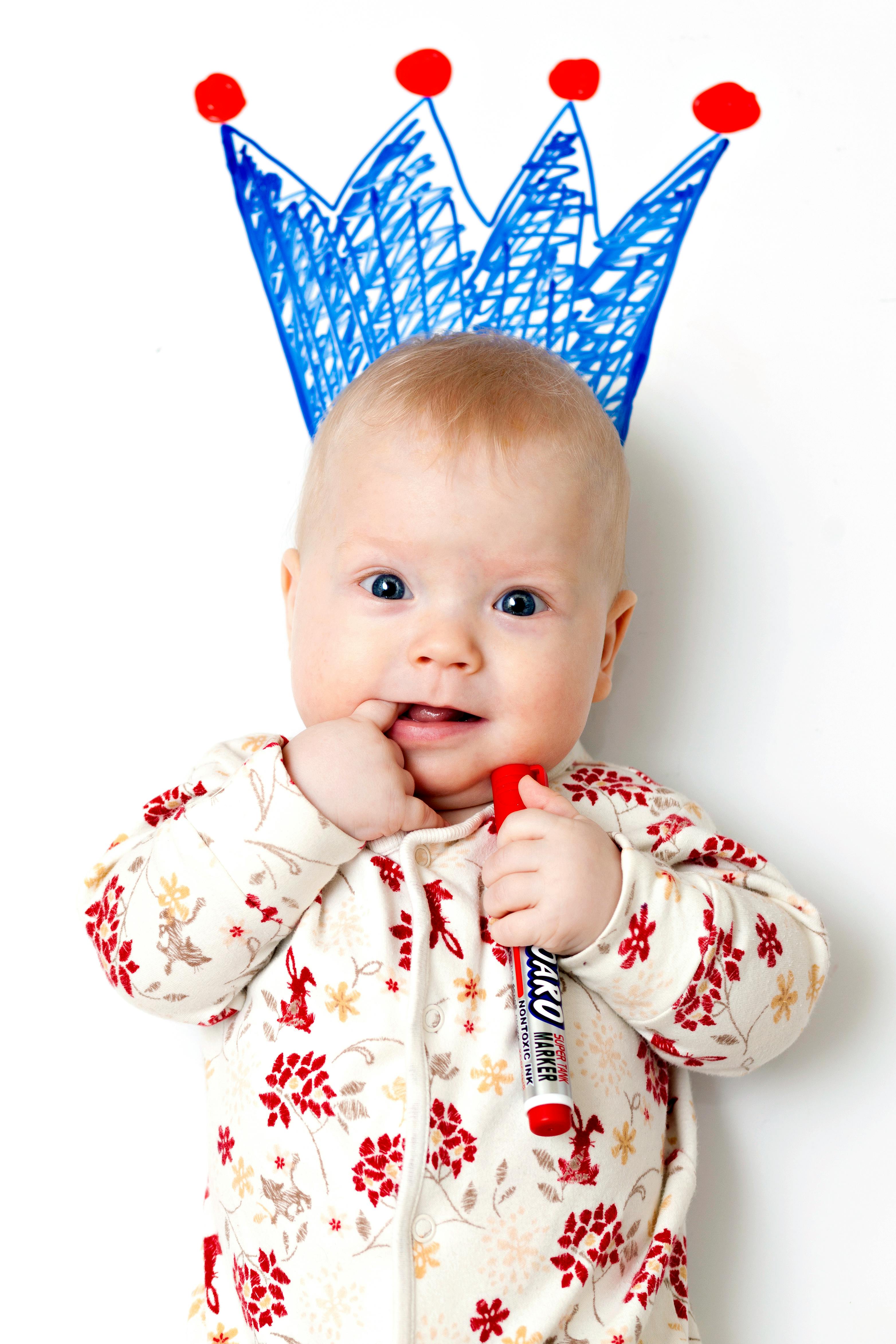 baby in white and red floral pajama