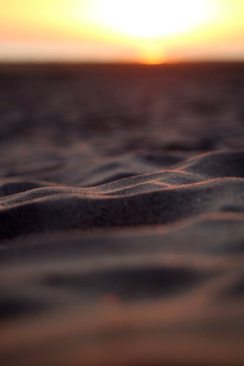 Close-Up Shot of Sand during Sunset