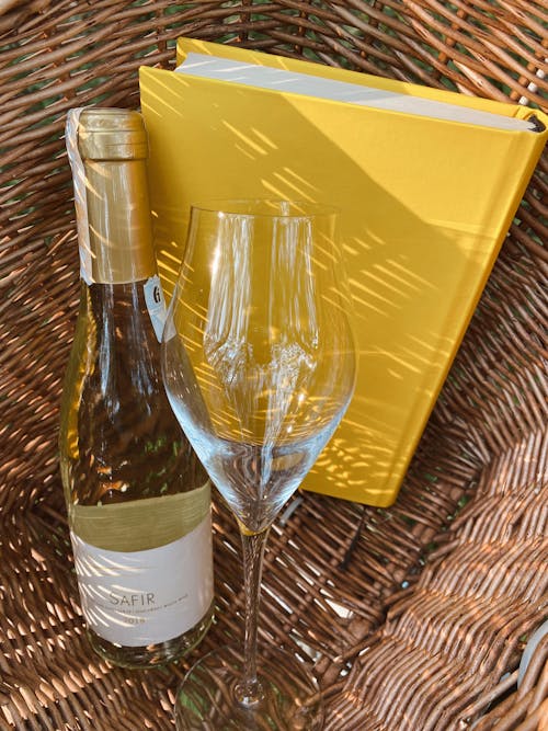 Free 
A Bottle of Wine, a Wine Glass and a Book in a Basket Stock Photo