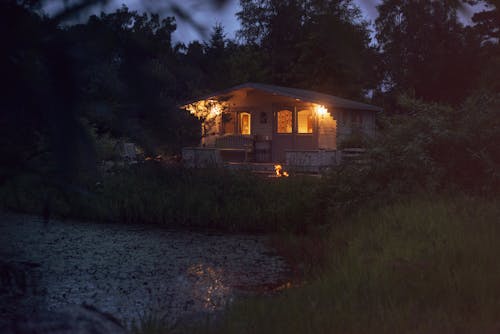 Wooden House in a Forest in the Evening 