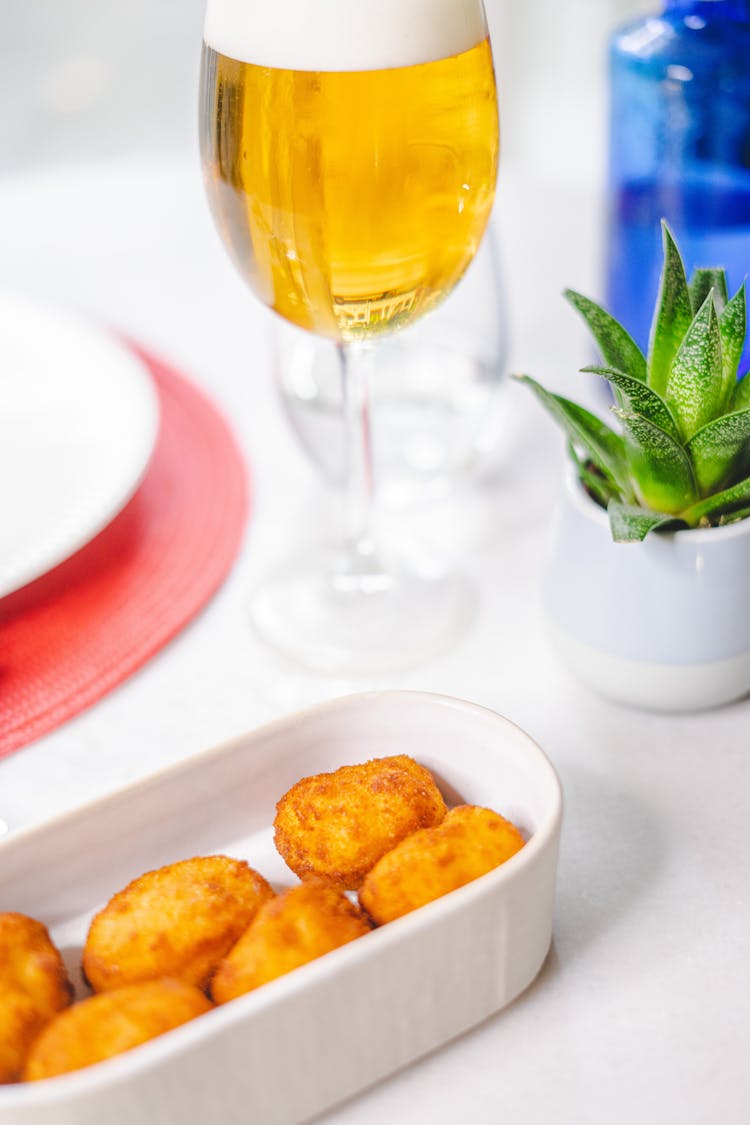 Tater Tots Served In Bowl With Glass Of Beer