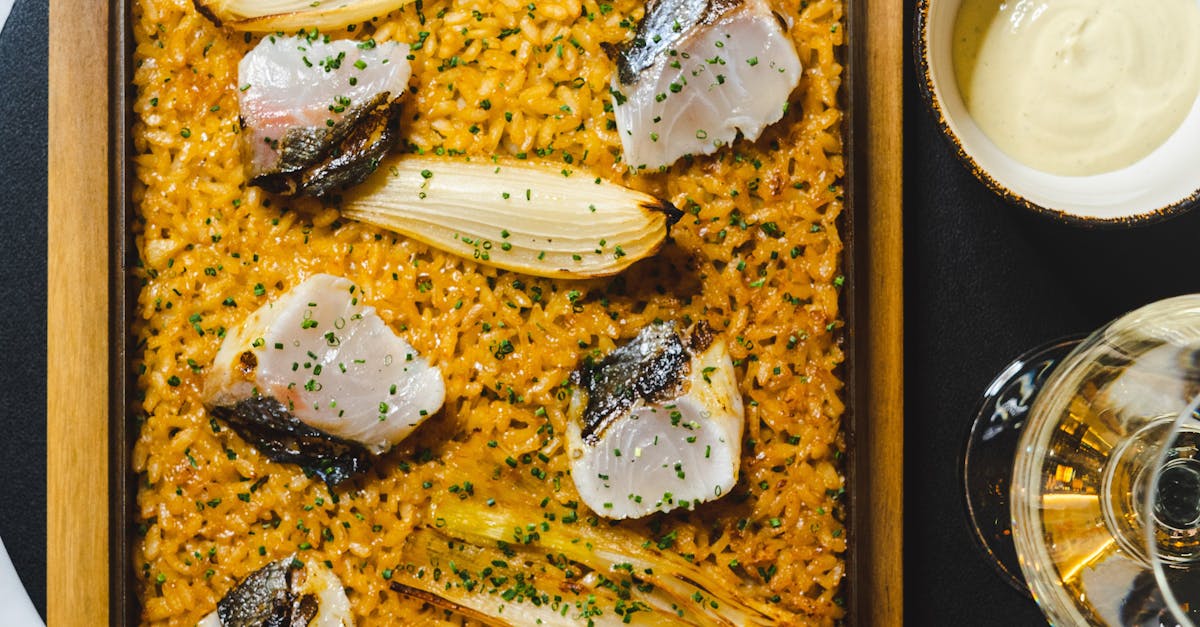A plate of artisanal Spanish cheeses paired with assorted fruits and nuts.