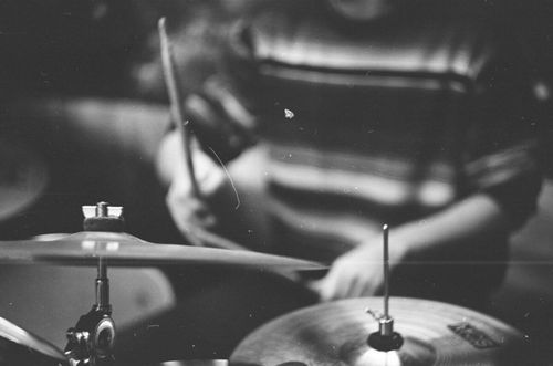 Free Artistic black and white photo of a drummer playing cymbals with selective focus. Stock Photo