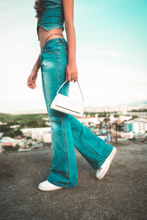 Free Close-Up Photo of a Person in Denim Clothes Carrying a White Handbag Stock Photo
