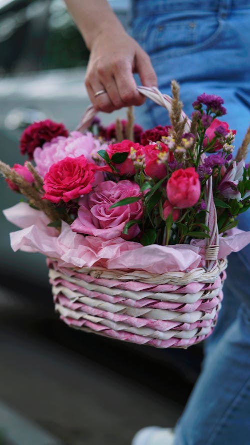 Free Close-Up Shot of a Person Holding a Basket of Flowers Stock Photo
