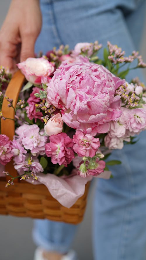 Free Close-Up Shot of a Person Holding a Basket of Flowers Stock Photo