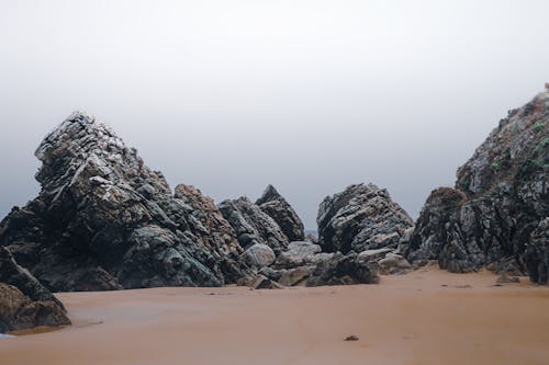Gray Rock Formations on the Sand 