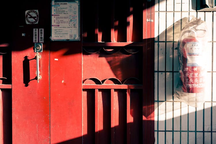 Fire Extinguisher Near Red Metal Door