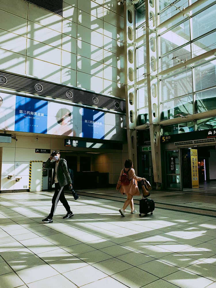 Man And Woman Walking On Airport 