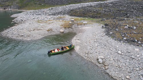 Aerial Photography of People Riding a Boat on the River