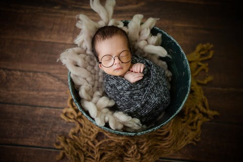 A Baby Sleeping in a Basket 