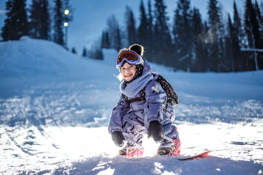 A happy child snowboarding in a snowy forest during winter, enjoying outdoor fun.