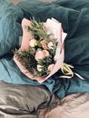Pink and Green Flower Bouquet on Bed Sheet