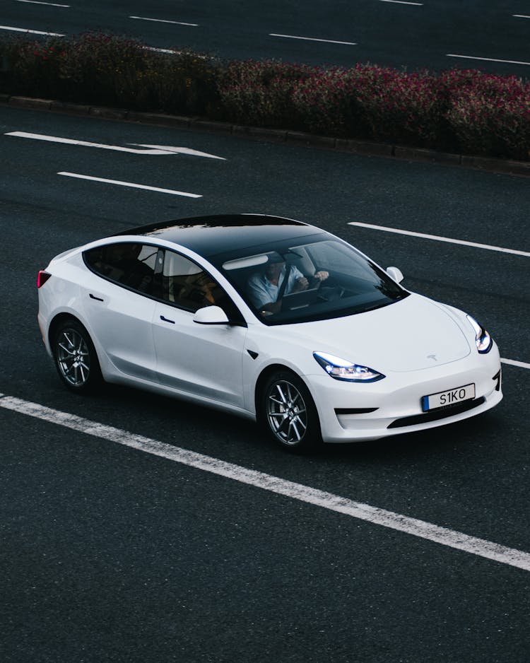 White Tesla Model 3 Car On Road 