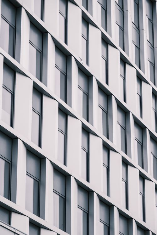 Free Low angle view of a modern building facade with grid pattern in grayscale. Stock Photo