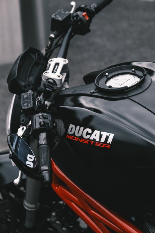 Free Detailed view of a Ducati Monster motorcycle's fuel tank, showcasing sleek design. Stock Photo