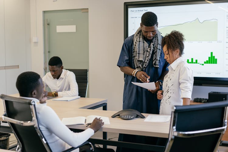 Man And A Woman Discussing A Document