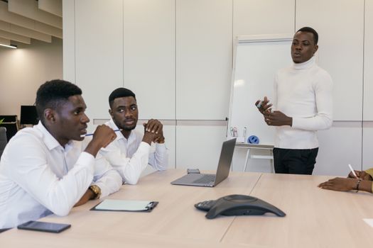 Professional team engaged in brainstorming session in modern office.