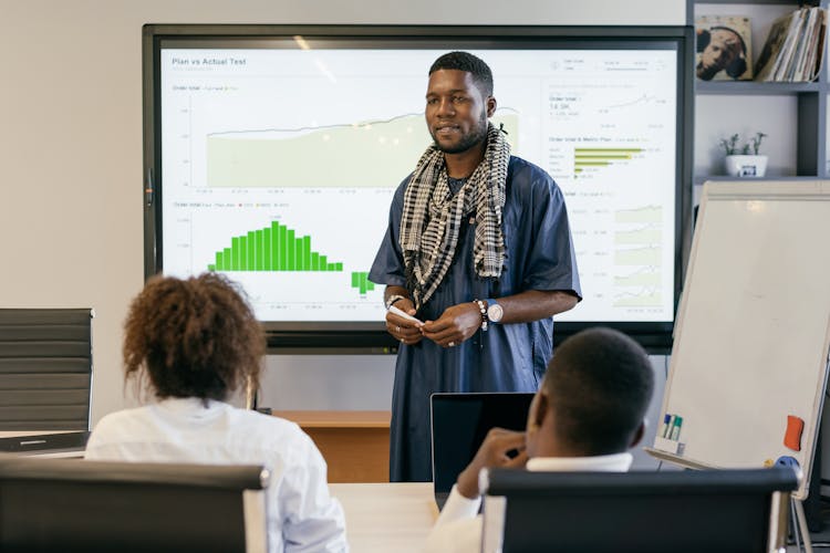 A Man Making A Business Presentation To Colleagues