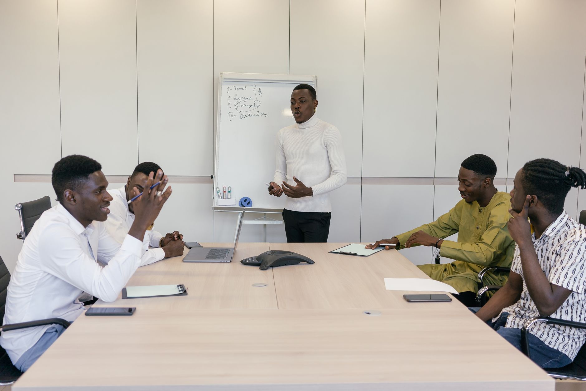 A group of professionals engaged in a business meeting in an office setting.