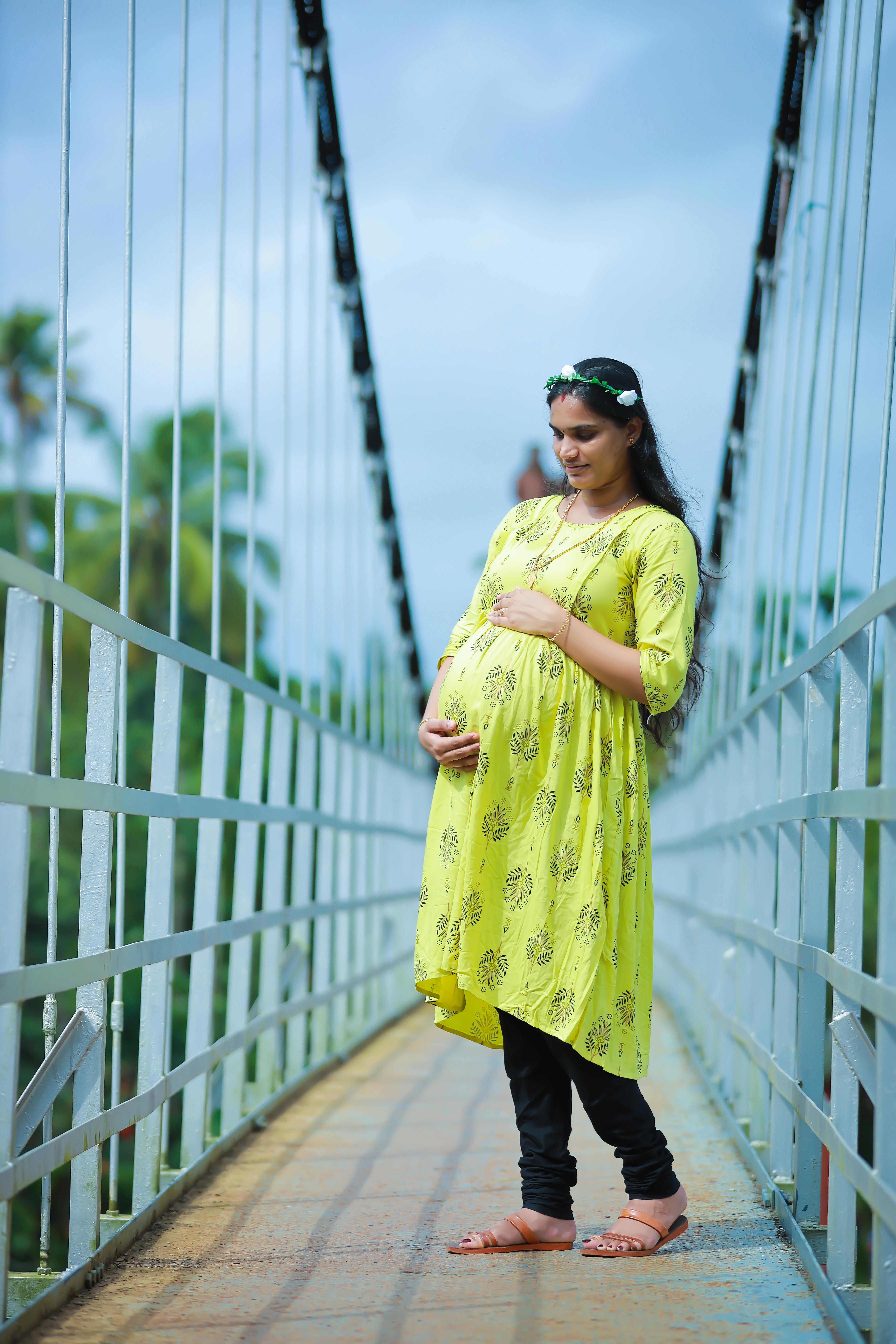 Pregnant woman is wearing blue sari, Stock image
