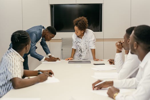 A diverse group of colleagues engaging in a productive office meeting around a conference table.