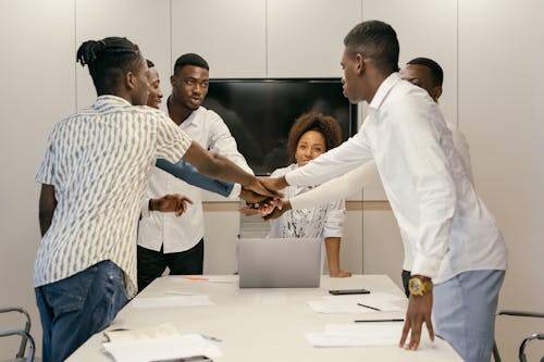 A Group of People Joining Hands Together