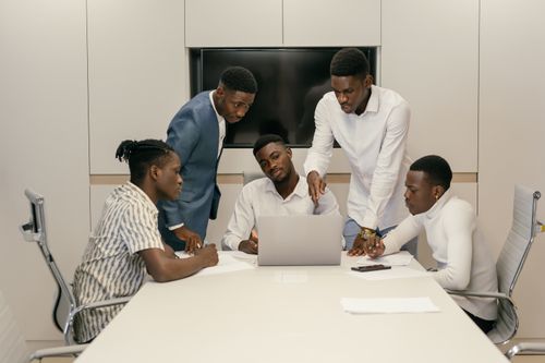 Free Young professionals brainstorming and collaborating in a modern conference room setting. Stock Photo