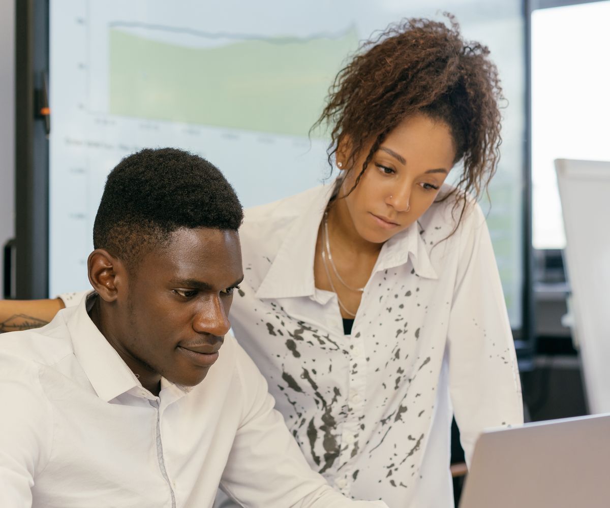 Hosting support specialists collaborating at a laptop