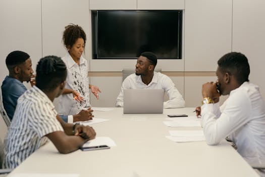 A diverse team of professionals collaborating in a modern office meeting environment.