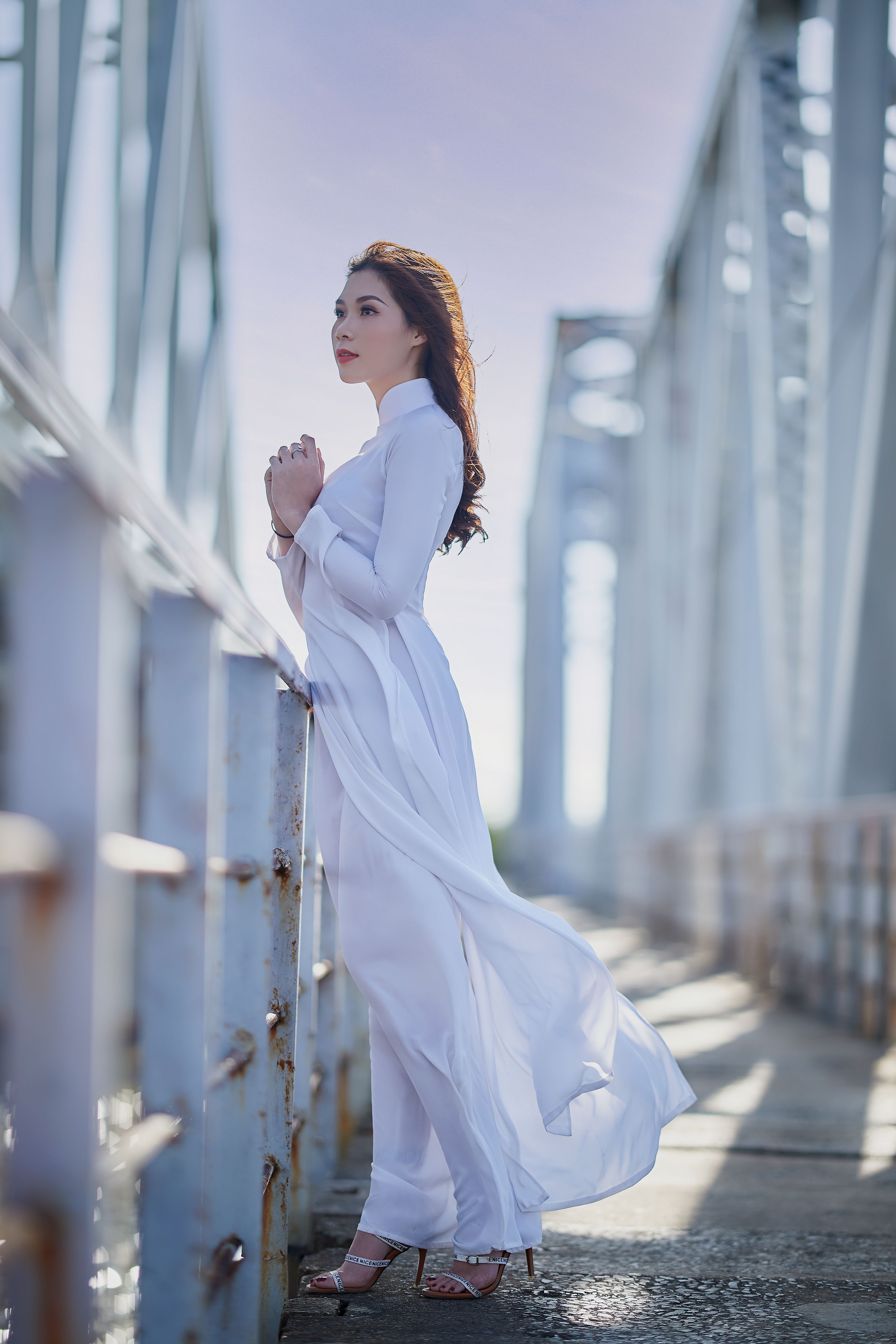 A Woman in White Dress Standing Near the Metal barrier · Free Stock Photo