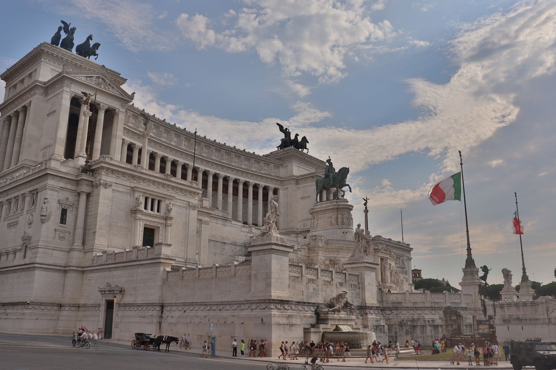 View of Altare della Patria in Rome with Italian flags and a clear sky.
