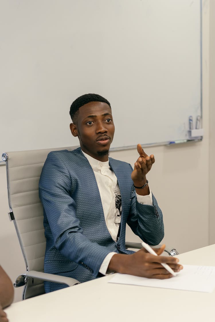 Man In Blue Coat Attending A Business Meeting