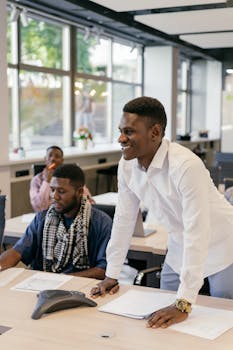 Diverse professionals engaged in a collaborative business meeting in a modern office setting.
