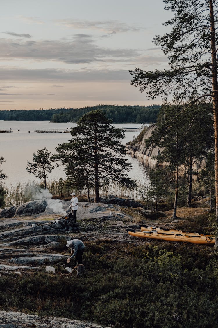 Men Camping Outdoors Near A Lake