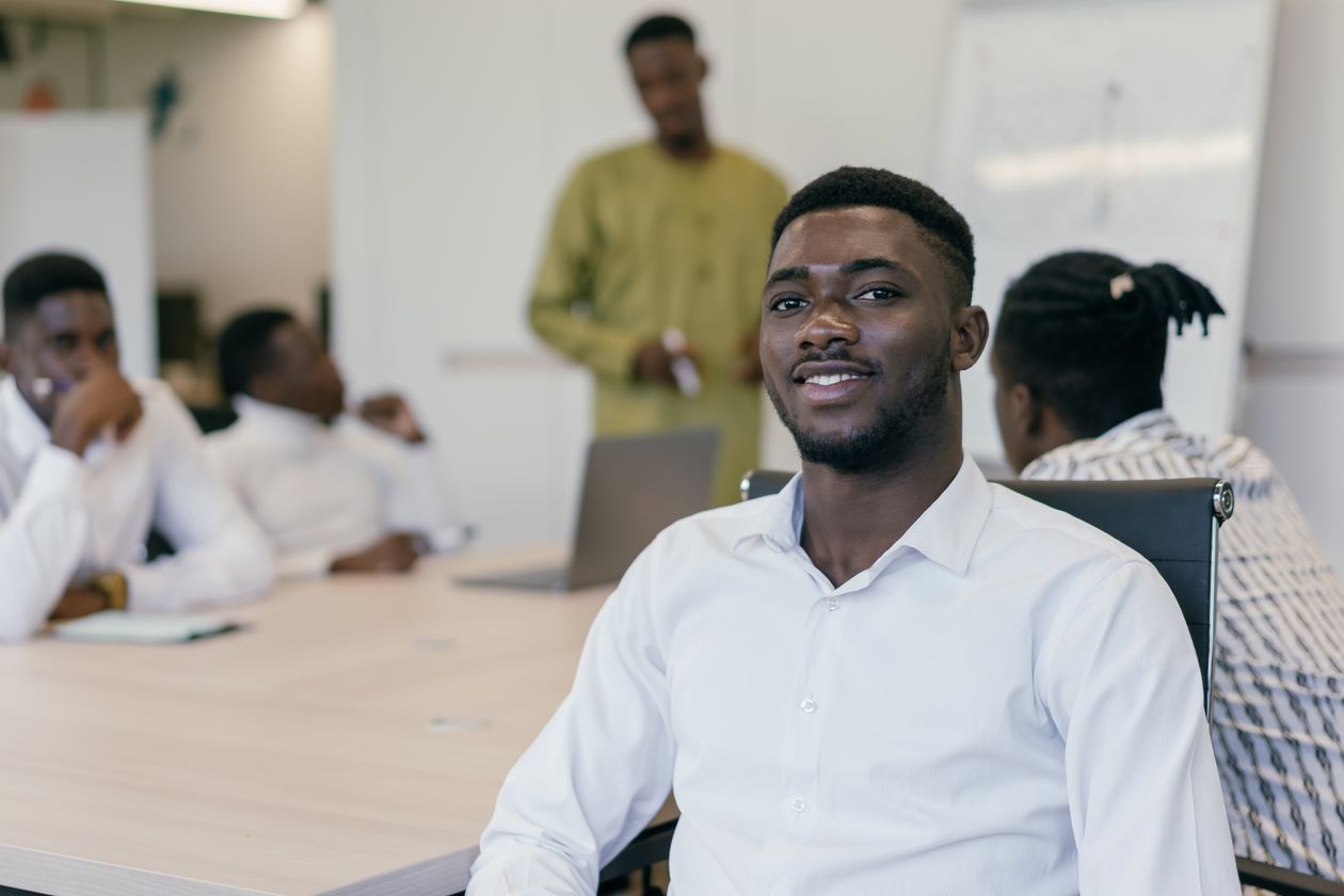 A confident African professional smiling in a modern office