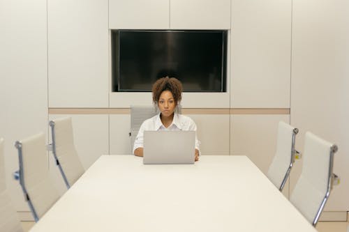 Woman Sitting in an Empty Conference Room